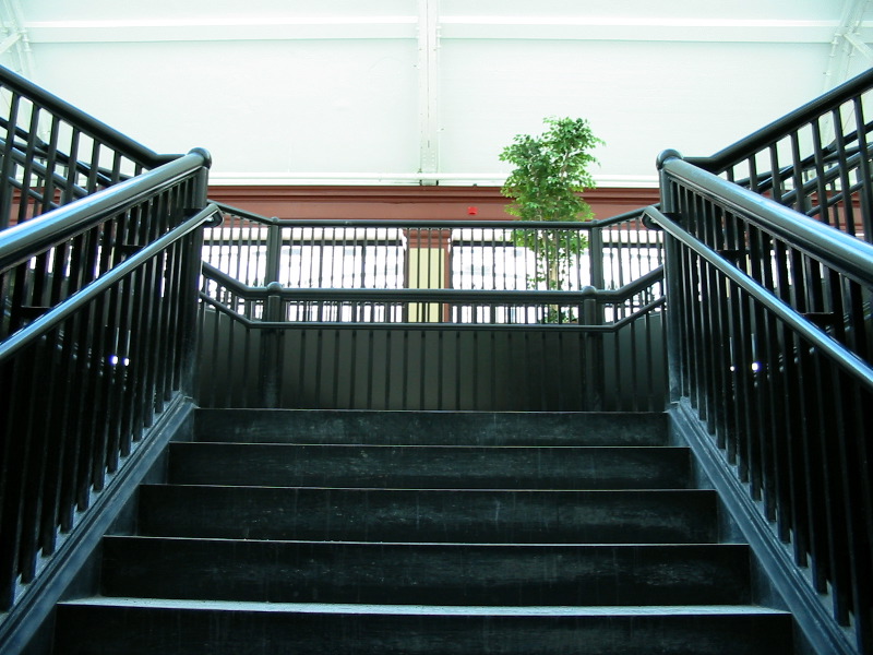 The stairway, at the other end of the room.