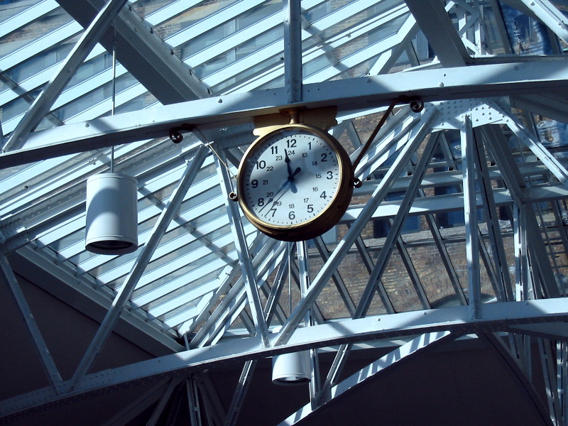 The clock surrounded of the iron masonry of the canopy.